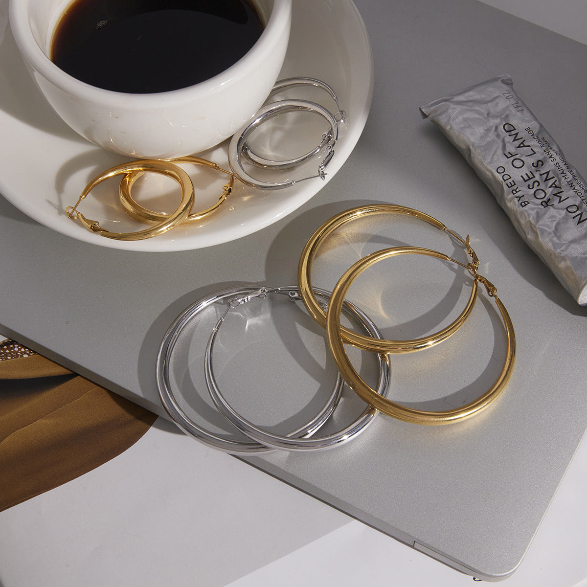 gold plated and silver-finish graduated hoop earrings arranged by size