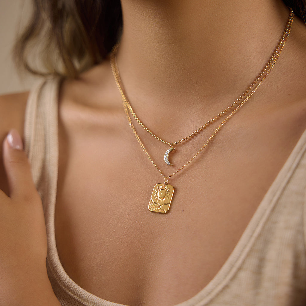 Two-chain sun and moon necklace worn by model