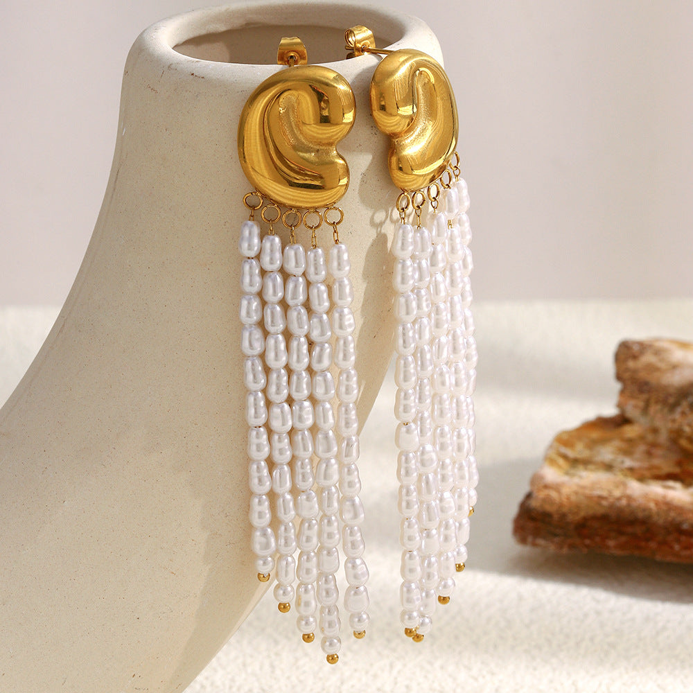 long white imitation pearl tassel earrings hanging on a display
