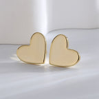 polished gold plated heart stud earrings in a close pair view