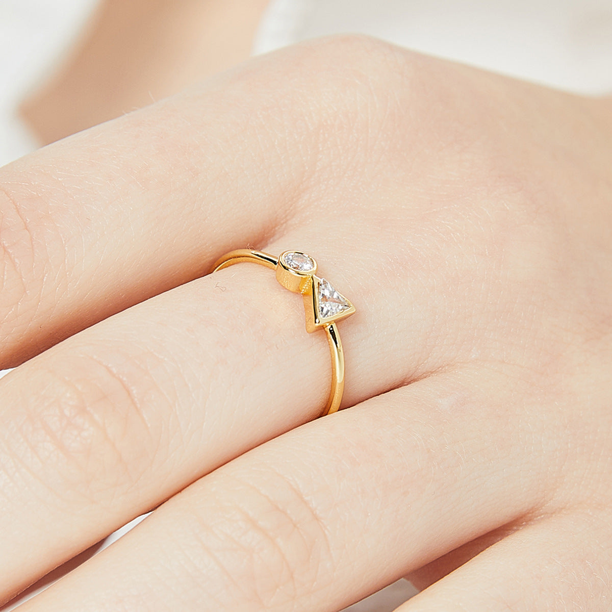 triangle and round zirconia ring worn on the finger