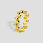 isolated gold plated sculpted oval pebble band ring