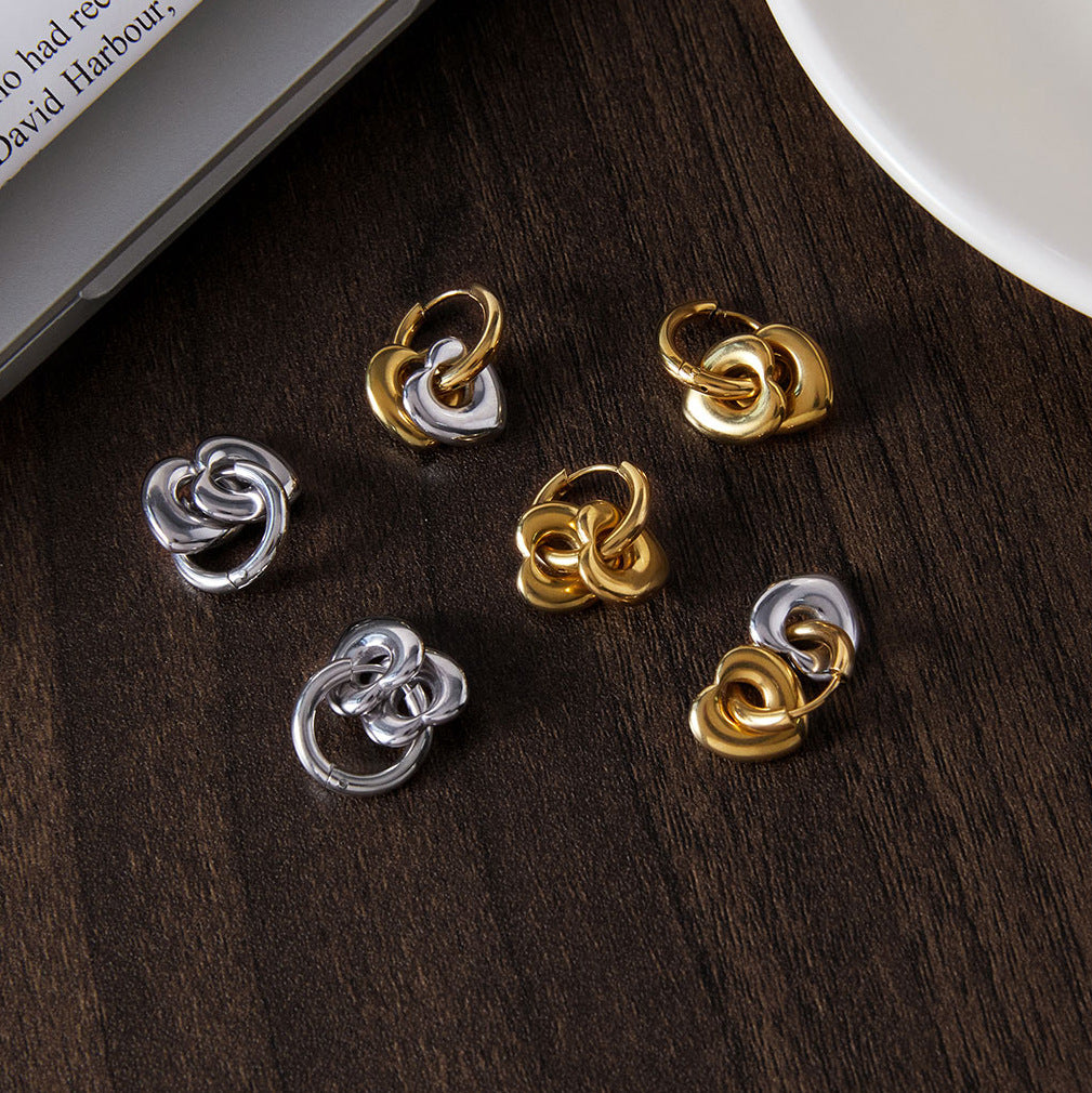 Heart hoop earrings styled beside other polished earrings