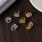 Heart hoop earrings styled beside other polished earrings