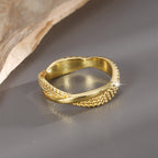 rear view of smooth back band on textured crossover ring