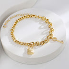 gold plated padlock and key anklet styled on a white display