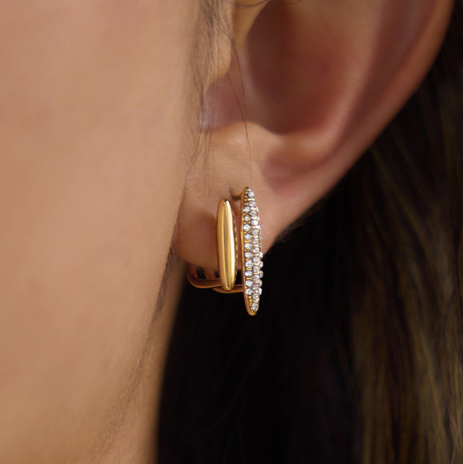 Double marquise earring with polished and clear-stone elements on ear