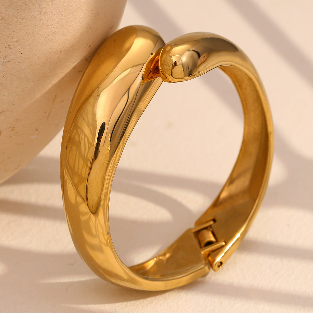 polished gold plated snake-head hinged bangle standing upright