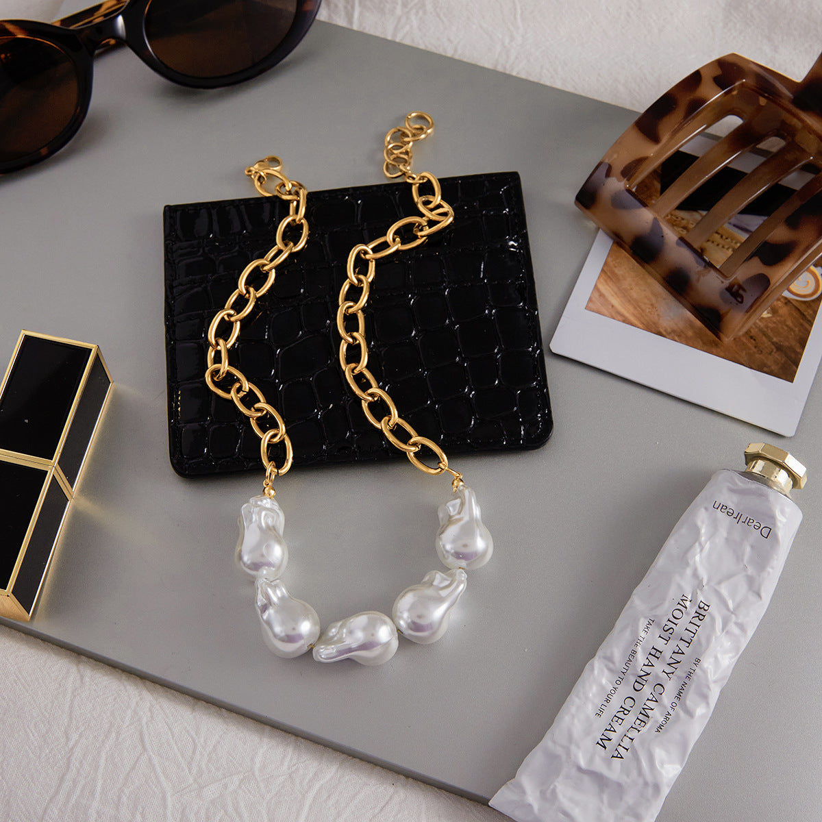 Mixed-texture necklace displayed with a matching bracelet