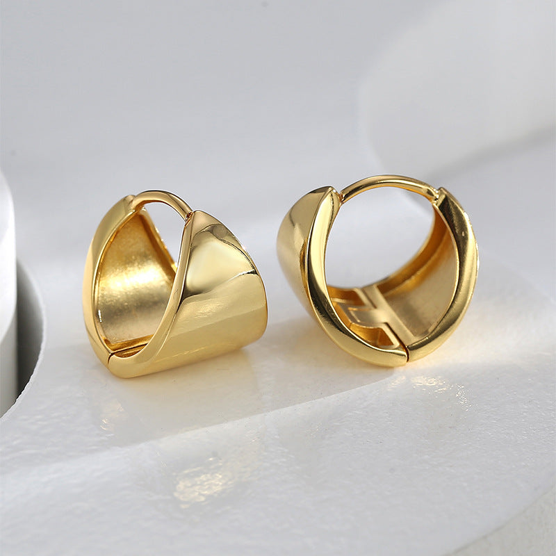 pair of gold plated sculptural shield hoop earrings