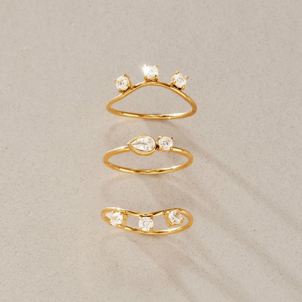 Three individual curved and eye motif rings separated