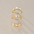 Three individual curved and eye motif rings separated