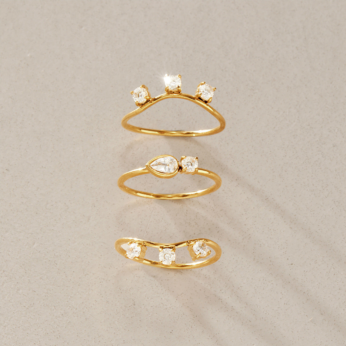 Three individual curved and eye motif rings separated