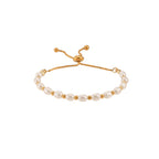 isolated gold plated stainless steel bracelet with freshwater pearls and slider