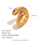 Gold-tone ring showing grooved shoulders and clear stones