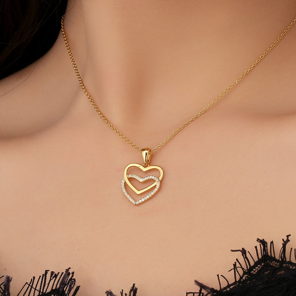 gold plated open double heart pendant necklace worn at the collarbone