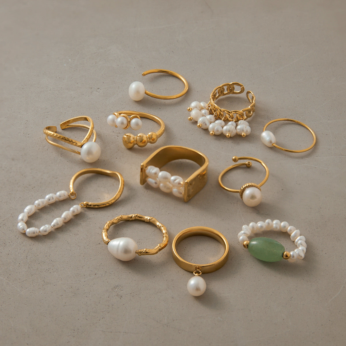Gold-tone pearl rings arranged on display