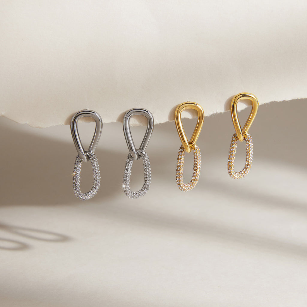 Gold and silver tone stone-accented link earrings displayed together