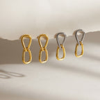 Plain gold and two tone teardrop link earrings hanging in pairs
