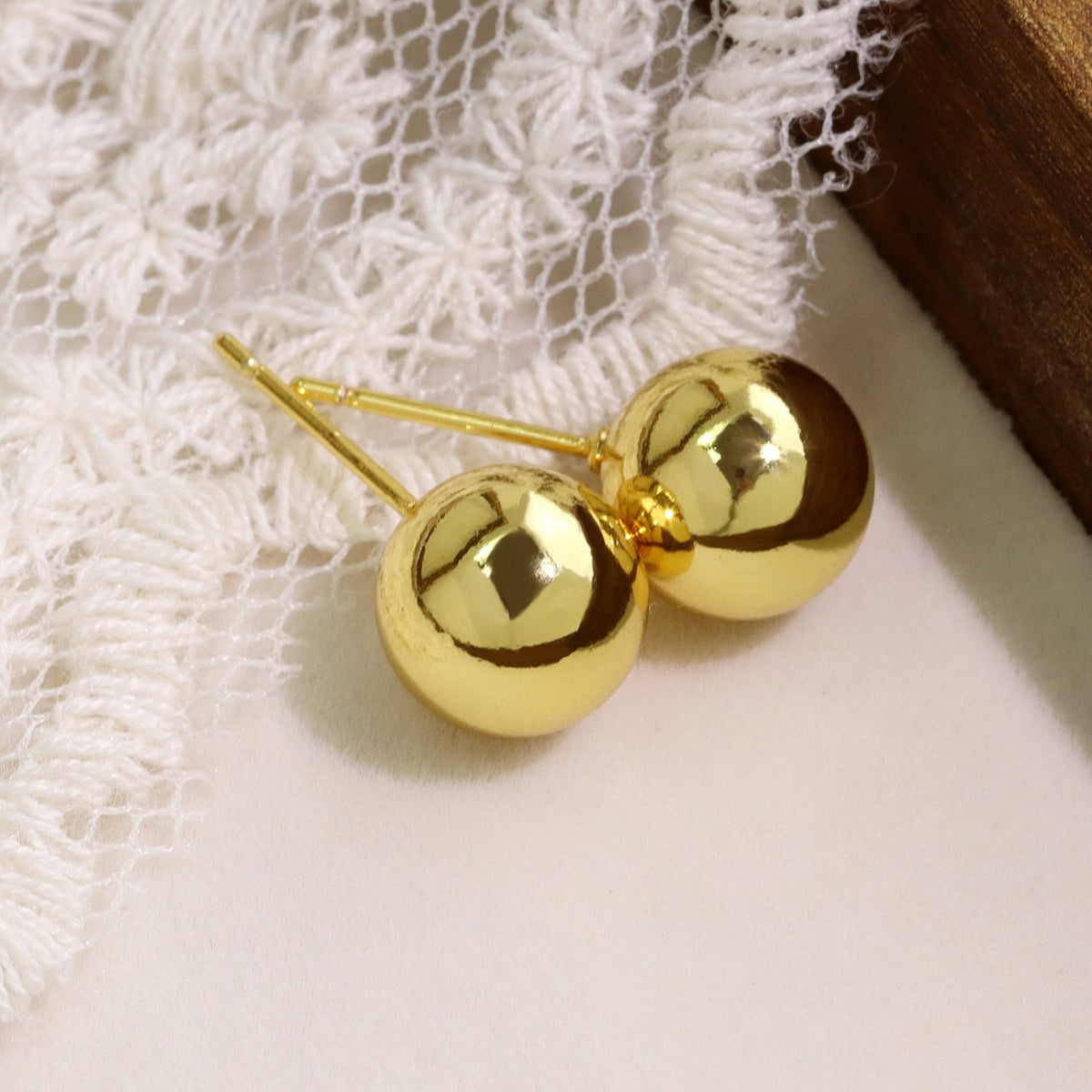 close view of round gold plated brass studs