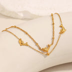 Gold plated dolphin bracelet laid flat