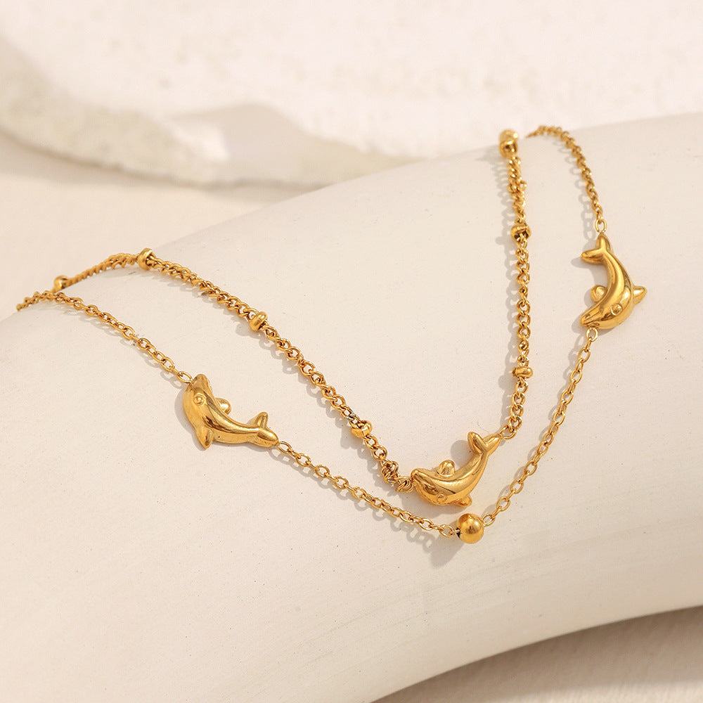 Gold plated dolphin bracelet laid flat