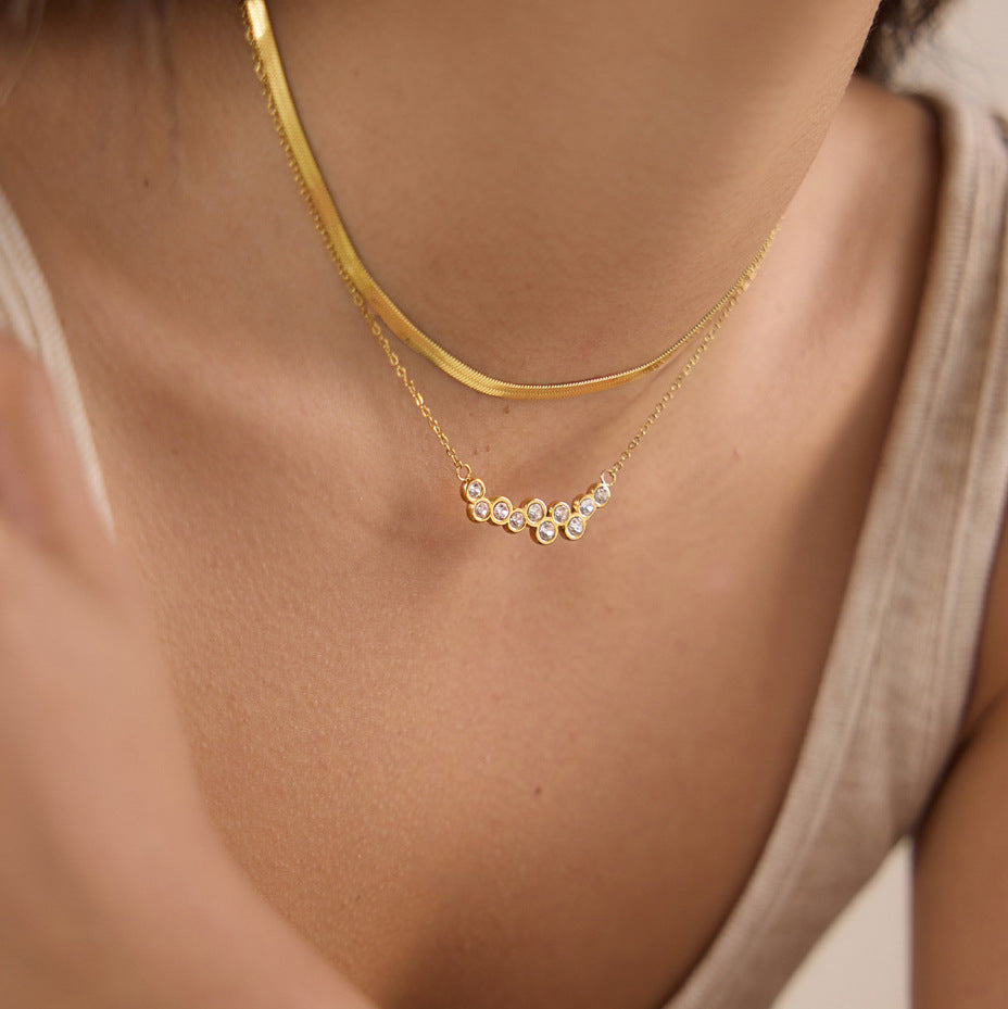 Round stone necklace layered with a flat chain