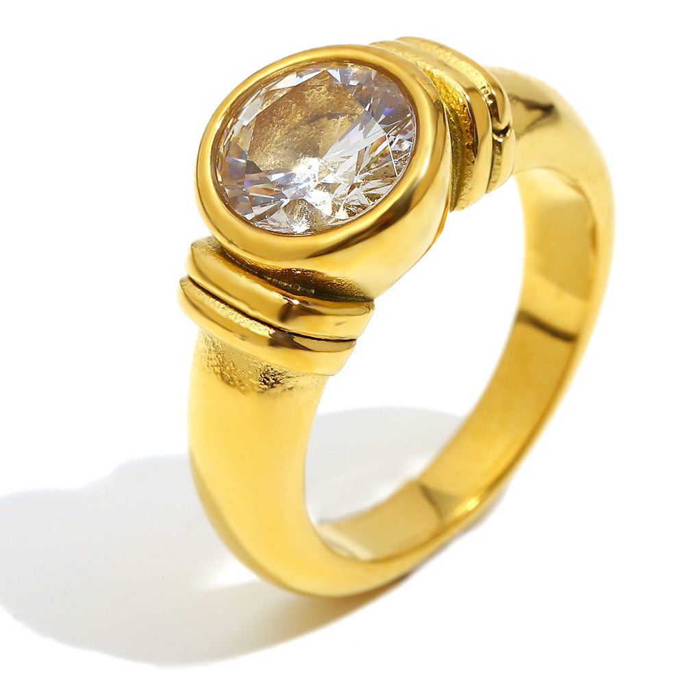 isolated gold plated stainless steel ring with round clear stone