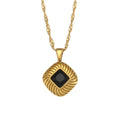 isolated gold plated square pendant necklace with a black stone