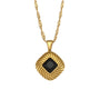 isolated gold plated square pendant necklace with a black stone