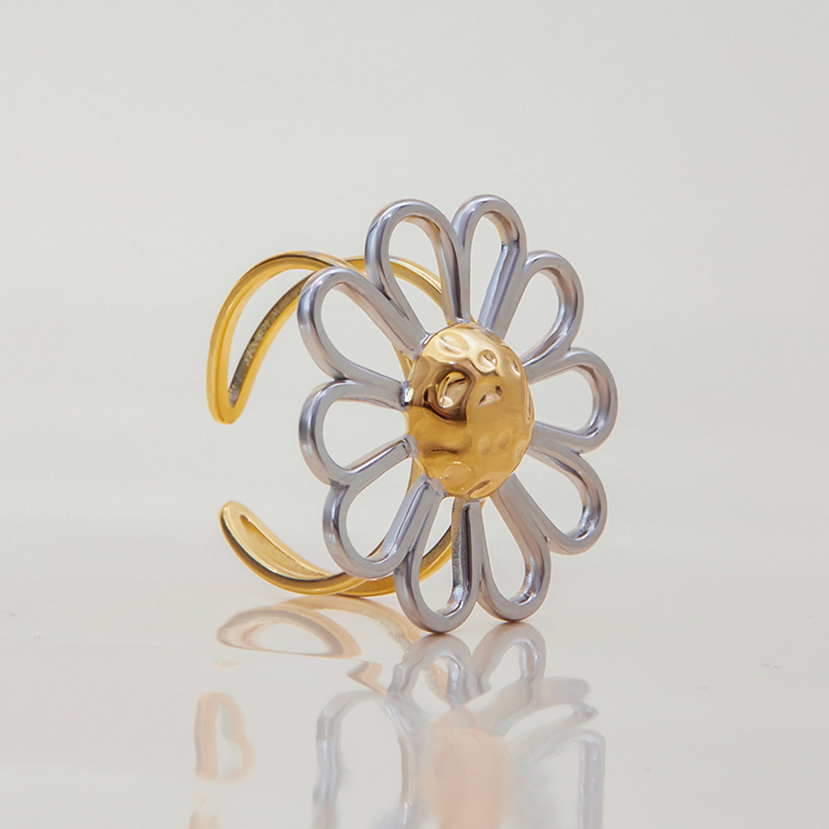 Side view of silver loop petals and textured gold center