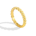 three-quarter studio view of the gold plated beaded band ring