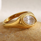 gold plated stainless steel signet ring with a marquise clear stone