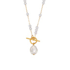 isolated gold plated asymmetrical toggle necklace with white beads