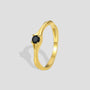 gold plated brass solitaire ring with a round black stone