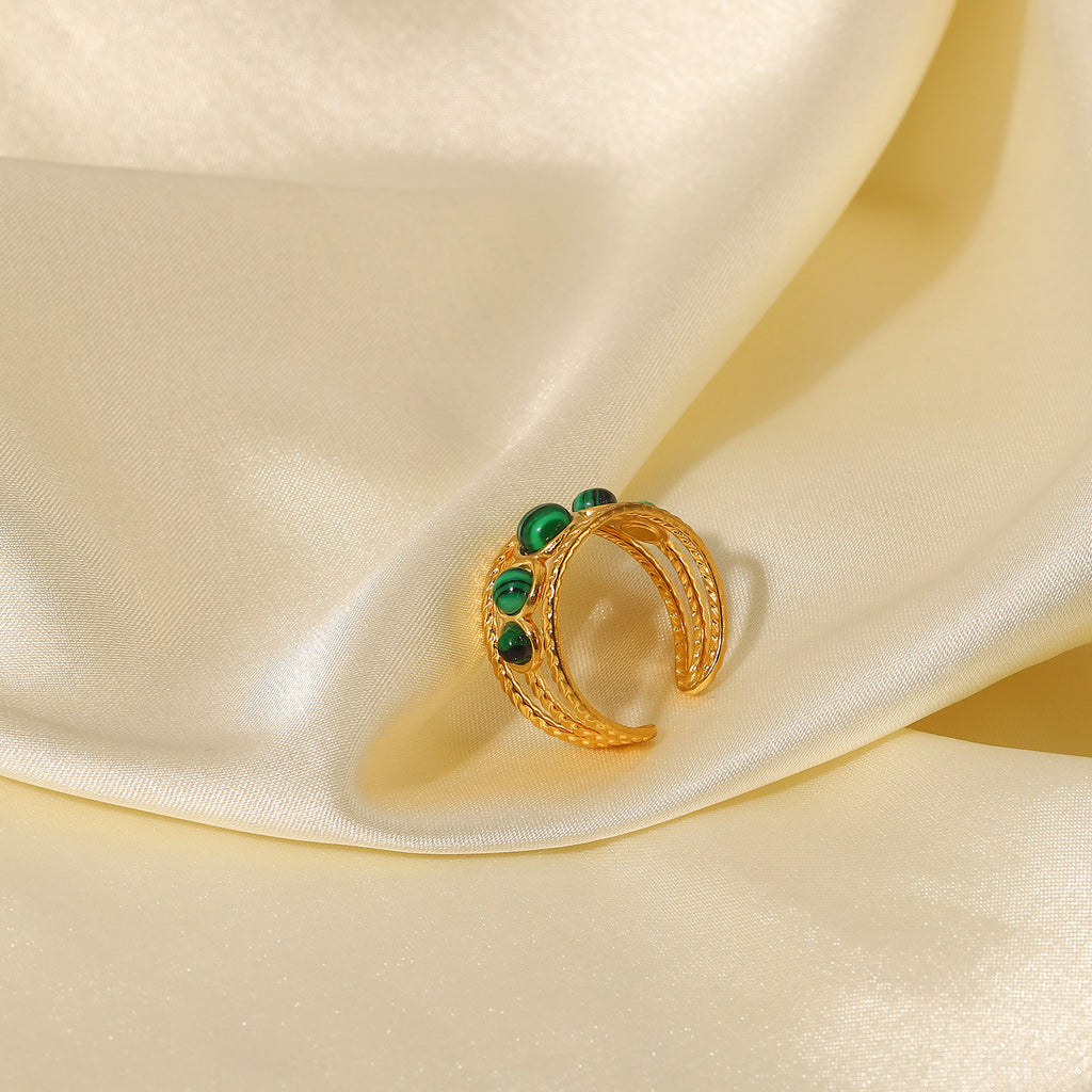 Green stone stainless steel ring in a styled display