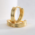 close-up of gold plated triple-ridge huggie hoop earrings