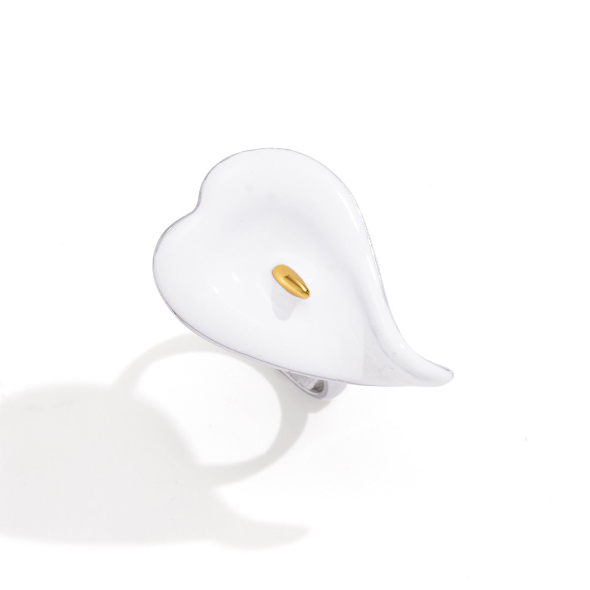Front view showing curled white petal and gold tone center