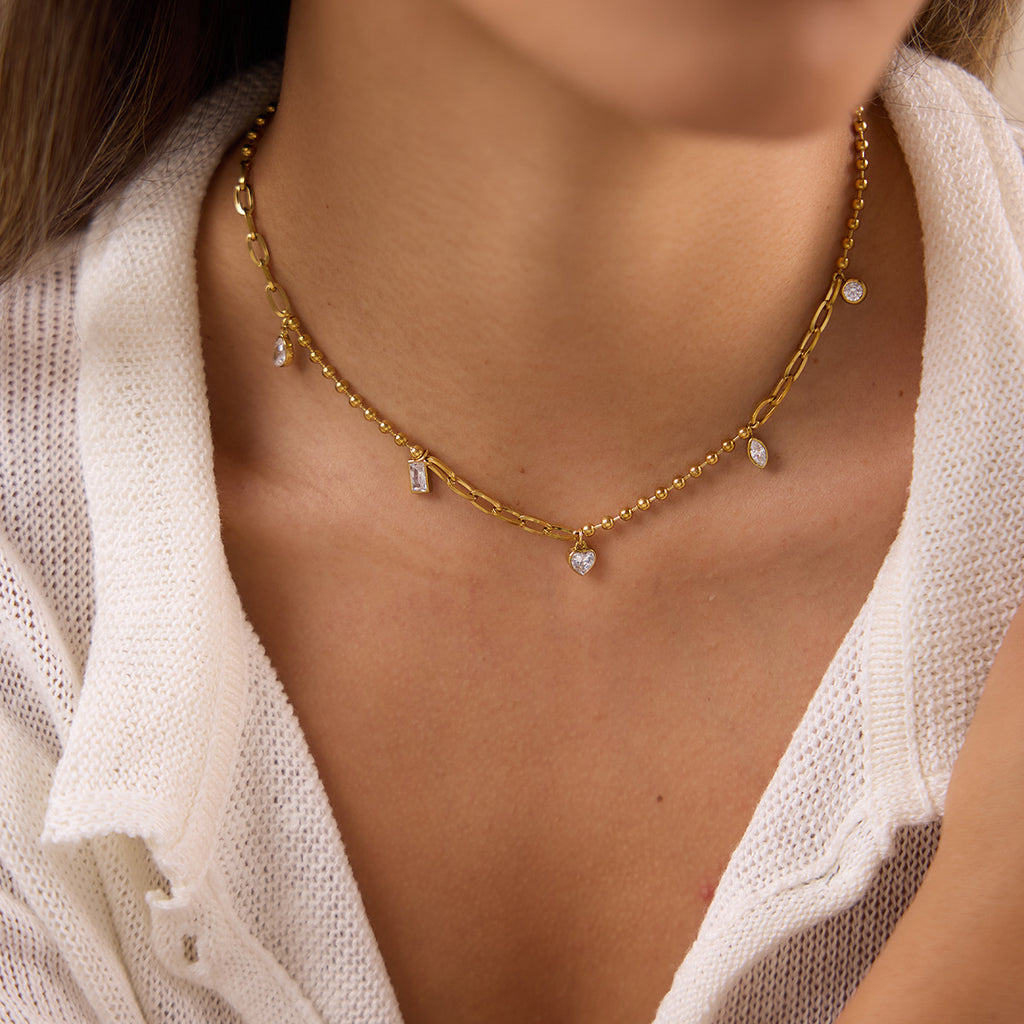 Single mixed-shape charm necklace at neckline