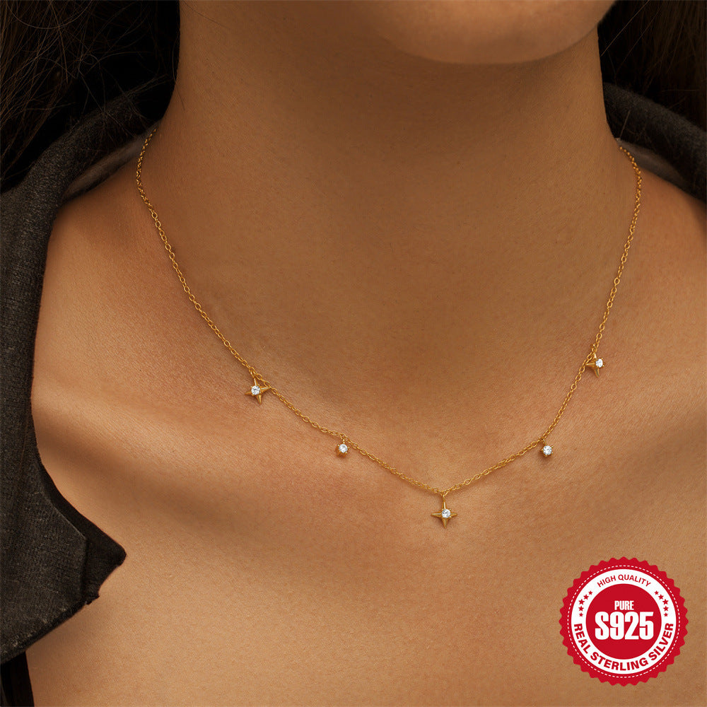 model wearing the delicate four-point star station necklace