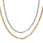 Layered stainless steel chains with spaced white faux pearls