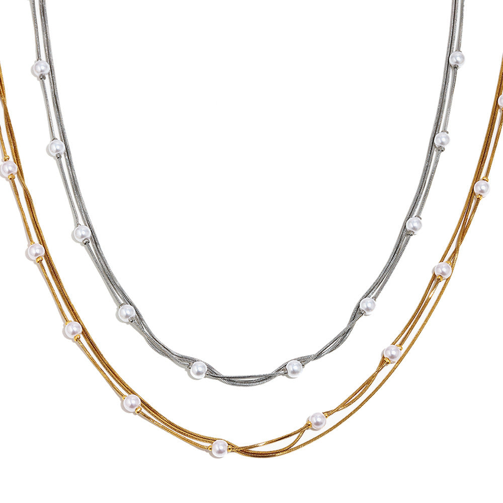 Layered stainless steel chains with spaced white faux pearls