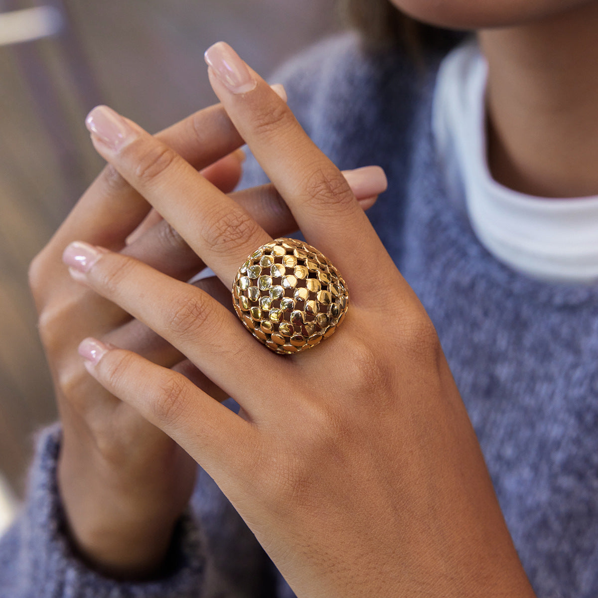 model wearing the gold plated stainless steel lattice dome ring