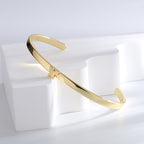 butterfly cuff bracelet balanced across a white display