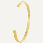 gold plated asymmetric open cuff bracelet on a white background