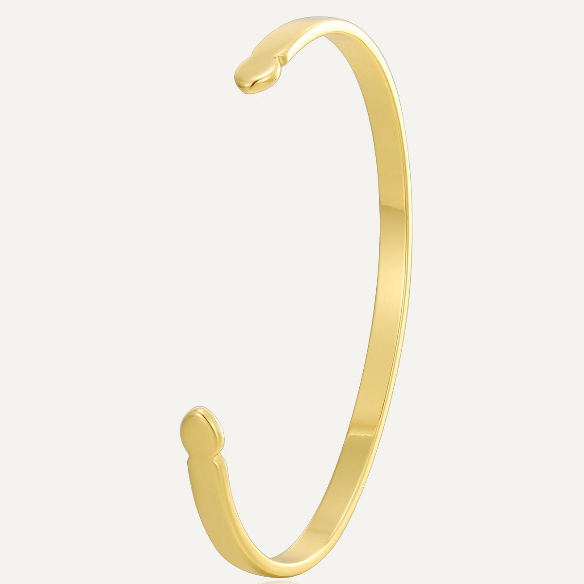 gold plated asymmetric open cuff bracelet on a white background