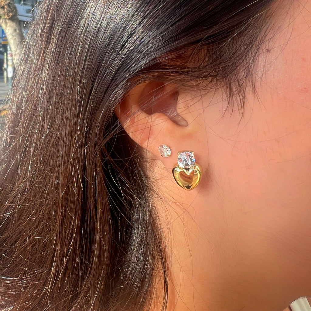 model wearing gold plated clear stone heart drop stud earrings