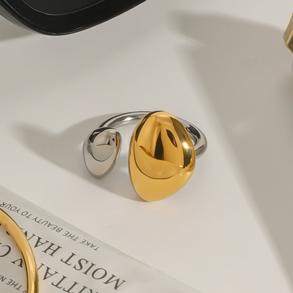 Two-tone open ring with unequal domed oval ends