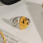 Two-tone open ring with unequal domed oval ends