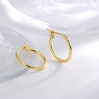 angled pair of polished gold plated classic round hoops
